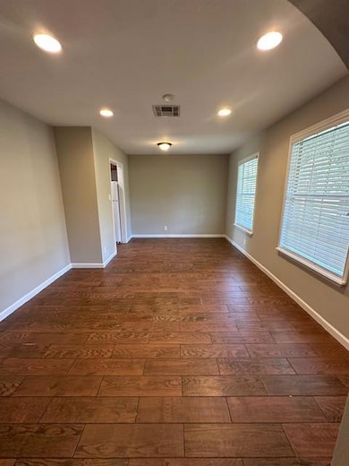 Unfurnished room with dark wood finished floors, 
