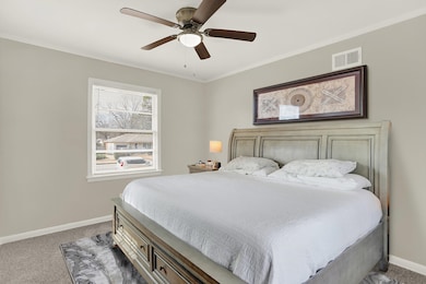 Bedroom with carpet flooring, baseboards, and ceiling fan