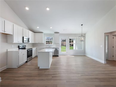 Kitchen with stainless steel appliances, pendant l