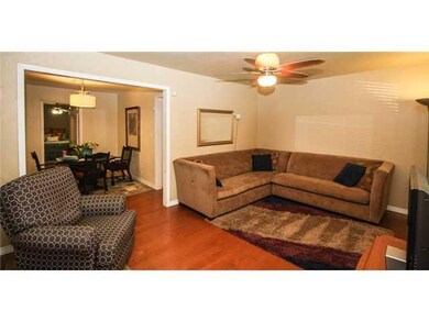 Living Room. This spacious living room fits this very large pit group and more!  Opens up to the dining area. Laminate floors have a real wood veneer.