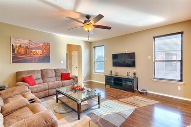 Living room with arched walkways, wood finished f