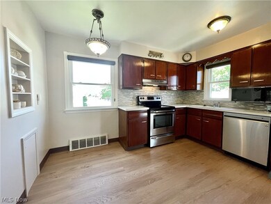 Kitchen with stainless steel finishes and tasteful backsplash