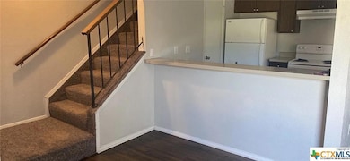 Kitchen featuring white appliances, under cabinet
