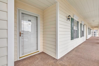 Entrance to property featuring covered porch