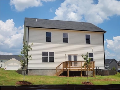 Rear view of house with a deck and a yard