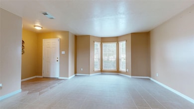 Bright living area at entry with bay window, great flex space for sitting area or study.