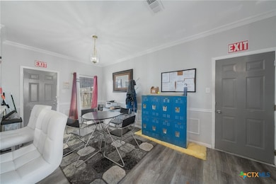 Dining space with dark hardwood / wood-style floor