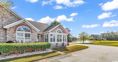 View of front of property with stone siding, concr