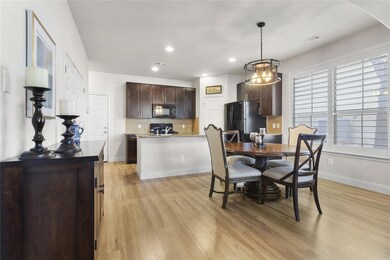 Dining room with light wood-style flooring, reces