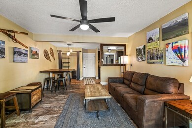 Living area featuring dark wood-type flooring, a c