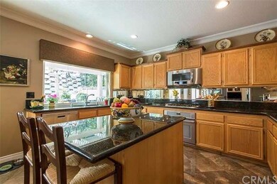 Remodeled kitchen with granite island has stainles