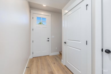 Entryway with baseboards and wood finished floors