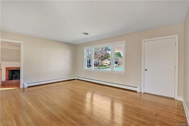 Large Living Room with fresh neutral paint, large picture window, and beautiful hardwoods
