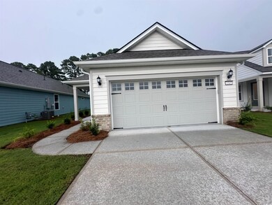 View of front of house with a garage, central AC, 