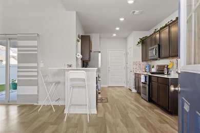 Kitchen featuring stainless steel appliances, dar
