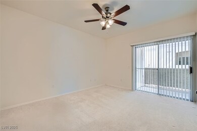 Spare room featuring carpet and a ceiling fan