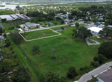 Bird’s-eye view highlighting the lot’s prime location near neighborhood amenities, schools, and just minutes from downtown Bradenton. This image captures the lot in context—positioned on a quiet stretch of 27th St E, with potential for rezoning to accommodate future growth. The nearby parks, residential homes, and open green space add to the appeal.