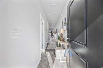 Corridor featuring dark hardwood / wood-style floo