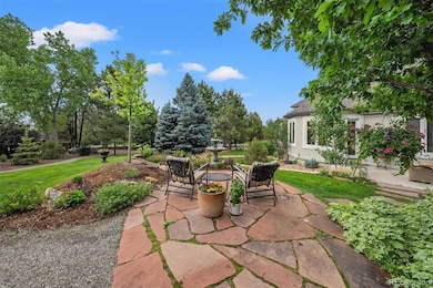 The backyard is more than just space—layered landscaping, multiple patios, and mature trees create an experience you won’t forget.