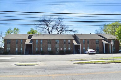 View of building exterior with uncovered parking