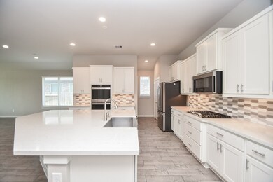 Thank goodness, long gone are the days of walled in space for specific purposes! A kitchen should be wide open and airy and linking with common living space! This is a picture of how it is!! You'll love the oversized, extended granite? quartz? (Maria: both are mentioned in HAR description) island countertop, inviting multiple comfy stools for quick, everyday snacking and the perfect surface for hors d'oeuvres, when entertaining.
