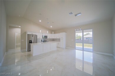 Oversized Living Room With View Into The Kitchen And Dining Area With Dual Hurricane Sliders That Lead Out To A Covered Lanai!