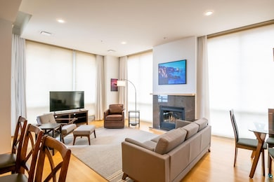Living room with light hardwood / wood-style floor