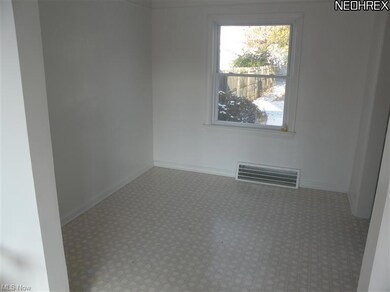Dining room with newer linoleum floor.