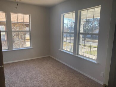 Empty room with healthy amount of natural light and light colored carpet