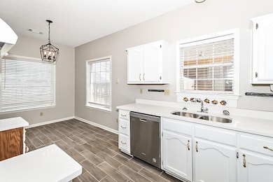 Kitchen with a sink, white cabinetry, stainless st