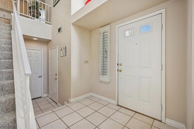Entrance foyer with light tile patterned flooring,