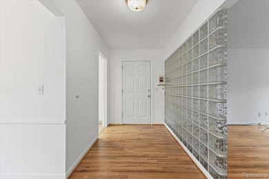 Hallway with light wood finished floors and baseboards
