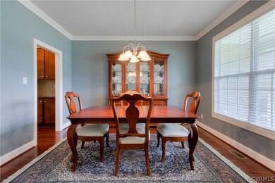 The Formal Dining Room includes hardwood floors, a transom window, and crown molding