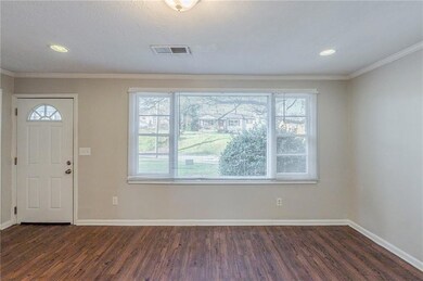 Foyer entrance featuring crown molding, baseboards