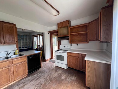 Kitchen with dark wood-type flooring, exhaust hood