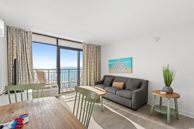 Living room with wood-type flooring, expansive win