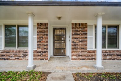 Beautiful Roman Doric style columns accent the covered porch w/ room for chairs if desired! An elegant wrought iron security door gives peace of mind while also adding to the curb appeal!