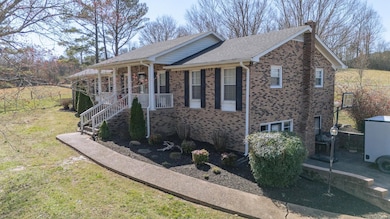 Single story home with a front yard, brick siding,