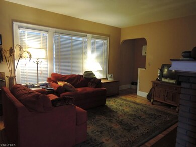Spacious living room with hardwood floor.