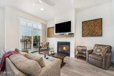 Living area with wood finished floors, a glass cov