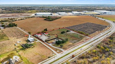 Aerial view of sparsely populated area featuring property boundaries highlighted and extensive farmland