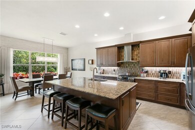 Kitchen featuring wall chimney range hood, a sink,