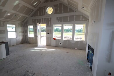 Open great room and dining area with vaulted ceili