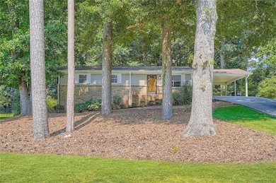 Single story home with an attached carport and brick siding