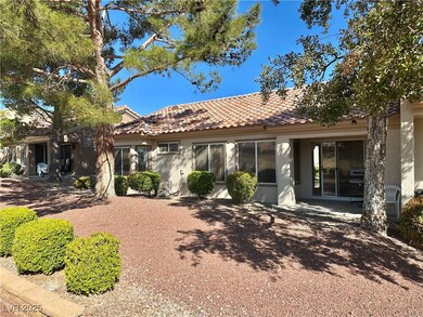 Rear view of house featuring stucco siding and a t