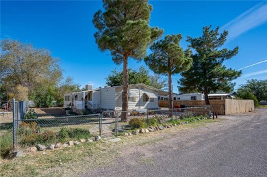 View of front of home with a fenced front yard and a gate