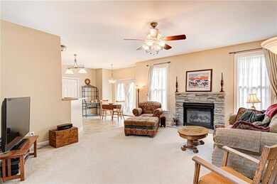 Spacious living room features gas log fireplace, ceiling fan, and large windows letting in tons of natural light.  Room is adjacent to the breakfast room and kitchen - what a great layout!