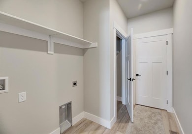 Washroom with washer hookup, light wood finished floors, and hookup for an electric dryer