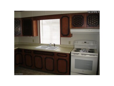 The kitchen includes new vinyl floor, new range an
