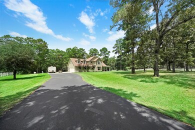 PICTURESQUE! Such a charming home! Recent asphalt driveway for plenty of parking as you enter the gate to this stunning home.  Bountiful trees surround this 2.00 acre property.  Need space to park your RV or boat, no problem. There is also a 30 amp RV plug outside of the garage. Need a barn or building, you definitely have an access point to place it where it best suits your needs.